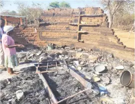  ?? ?? Gogo Concilia Moyo shows what was left of her two huts after they were set alight by a mentally-challenged man at Mpofu Village in Lupane