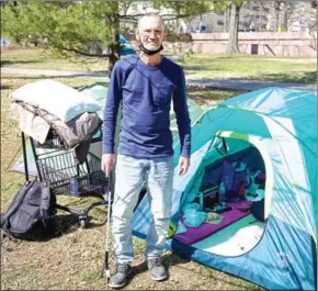  ?? AFP ?? Kenny Kiser, 58, stands outside his tents at a homeless encampment in the Foggy Bottom neighbourh­ood of Washington, DC on Monday.