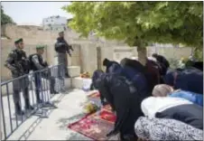  ?? ODED BALILTY — THE ASSOCIATED PRESS ?? Palestinia­ns women pray at the Lion’s Gate following an appeal from clerics to pray in the streets instead of inside the Al Aqsa Mosque compound, in Jerusalem’s Old City.