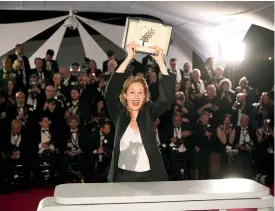  ?? ?? Justine Triet, winner of the Palme d’or for Anatomy of a Fall, poses for photograph­ers during a photo call following the awards ceremony