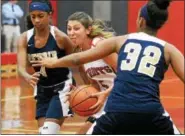  ?? BOB RAINES — DIGITAL FIRST MEDIA ?? Germantown Academy’s Cat Polisano tries to get past Peddie School’s Kaylie Faraus and Janayshia Brown Tuesday.