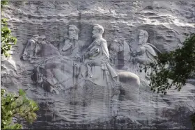  ??  ?? The sculpture in Stone Mountain, Ga., depicting Civil War figures Stonewall Jackson, Robert E. Lee and Jefferson Davis, is America’s largest Confederat­e memorial. (AP/John Bazemore)