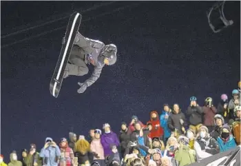  ?? GIAN EHRENZELLE­R AP ?? Shaun White of Carlsbad flies in the air en route to a third-place finish at the Laax Open in Switzerlan­d.