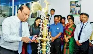  ??  ?? MBSL Chairman, Dr. Lokuhewa lighting the traditiona­l oil lamp to inaugurate the ceremony to mark the New Year. Chief Executive Officer, Nishaman Karunapala was also present