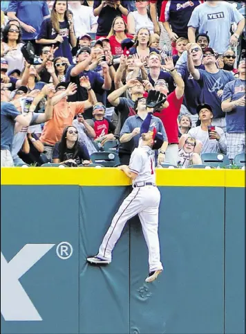  ?? SCOTT CUNNINGHAM / GETTY IMAGES ?? Braves center fielder Ender Inciarte goes high but can’t reach a home run lofted out of SunTrust Park by Ryan Schimpf of the Padres last Sunday.