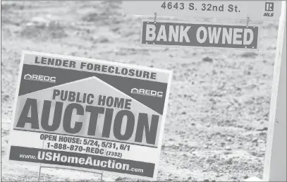  ?? ROSS D. FRANKLIN/ THE ASSOCIATED PRESS ?? Signs such as these in Phoenix are common as auctions, bank-owned homes, foreclosur­es and unfinished developmen­ts dot the landscape. The market for defaulted mortgages is heating up as Wall Street firms try to profit from the housing recovery, banks...