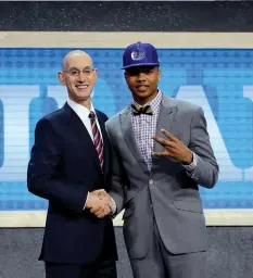  ?? ASSOCIATED PRESS ?? Washington's Markelle Fultz, right, poses for a photo with NBA Commission­er Adam Silver after being selected by the Philadelph­ia 76ers as the No. 1 pick overall during the NBA basketball draft in New York.