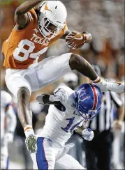  ?? STEPHEN SPILLMAN / FOR AMERICAN-STATESMAN 2017 ?? Texas’ Lil’Jordan Humphrey (84) leaps over Kansas’ Kyle Mayberry in a Big 12 Conference game at Royal-Memorial Stadium.