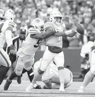  ?? MATT DURISKO/AP ?? Dolphins quarterbac­k Tua Tagovailoa is sacked by Bills defensive end Mario Addison on Sunday in Orchard Park, New York.