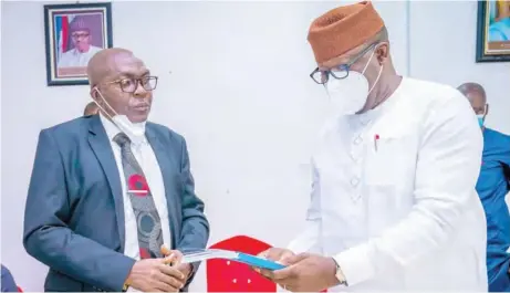  ??  ?? Kayode Fayemi (r), governor, Ekiti State, receiving final report of the state judicial panel of inquiry into allegation­s of human rights violations by police officers including operatives of SARS, from Cornelius Akintayo, chairman of the panel, in Ado-ekiti…on Friday