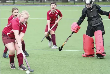  ?? ?? From left: Aztecs Hannah McAskill , Aztecs Chanae Bone, Aztecs Ryan Taylor against Drouids Goalie Damian McNamara.