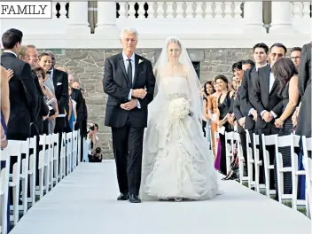  ??  ?? Proud fathers: President Bill Clinton walks daughter Chelsea down the aisle in 2010; and Chris Evans, below, with his daughter Jade in 2013