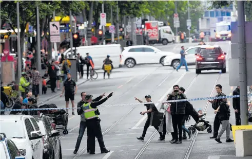  ?? Photo / AAP ?? Police cordoned off Bourke St in central Melbourne after yesterday’s attack.