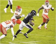  ?? NICK WASS/AP ?? Lamar Jackson tries to elude Chiefs defenders Monday night.