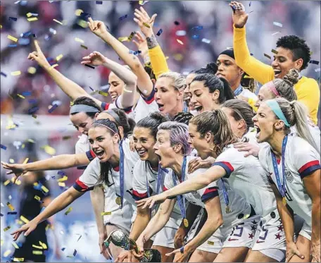  ?? Alex Grimm Getty Images ?? MEGAN RAPINOE holds the FIFA Women’s World Cup trophy after the U.S. team’s triumph over the Netherland­s in Lyon, France.