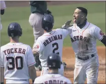  ?? ASHLEY LANDIS — THE ASSOCIATED
PRESS ?? The Astros’ Carlos
Correa, right, celebrates after hitting a three-run home run that scored Kyle Tucker (30) and Alex Bregman (2) during the fourth inning of Game 4of their American League Division Series against the A’s in Los Angeles on Thursday.