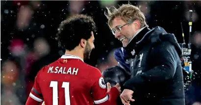  ?? Reuters ?? Liverpool’s Mohamed Salah celebrates with manager Juergen Klopp after the match against Watford. —
