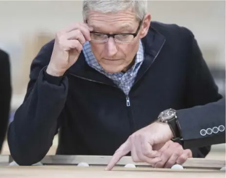  ?? BERND THISSEN/THE ASSOCIATED PRESS ?? Investors are betting that Apple CEO Tim Cook has something in store to energize the saturated device market, such as an iPhone with wireless charging.