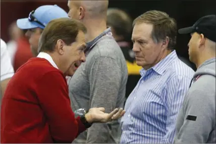  ?? ASSOCIATED PRESS FILE PHOTO ?? Alabama coach Nick Saban, left, speaks with New England Patriots coach Bill Belichick during Alabama’s pro day last March in Tuscaloosa, Ala.
