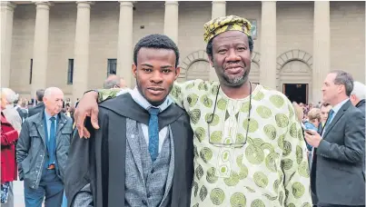  ??  ?? Sulaiman Badmus, who graduated in mechanical engineerin­g, with his father Abdulwahee­d, a Scots Law graduate.