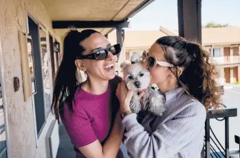  ?? MARK ABRAMSON/THE NEW YORK TIMES ?? Sisters Natasha and Ira Hrytsenko after they were reunited with their dog in California.