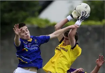  ??  ?? Wexford goalkeeper Joshua Burke comes under pressure from Jack Dunne of Wicklow.