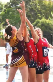  ??  ?? Despite being outnumbere­d, Drouin’s Taylah Marsh-Irwin won this battle for the ball against Bairnsdale’s Mia Clifford (centre) and Nellie Austin in B grade.