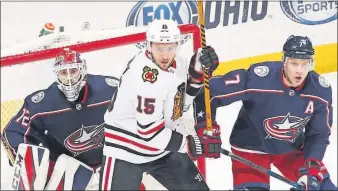  ?? [JOSHUA A. BICKEL/DISPATCH] ?? Blackhawks center Artem Anisimov and Blue Jackets defenseman Jack Johnson, right, battle for position in front of Jackets goaltender Sergei Bobrovsky during the first period Saturday in Nationwide Arena.