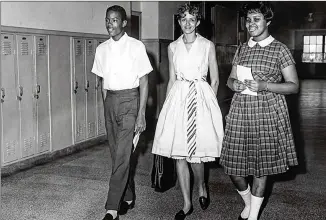  ??  ?? Students walk the halls at Brown High School in 1961. The ratio of Black students has been studied.