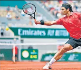  ?? AFP ?? Roger Federer returns against Marin Cilic at the French Open in Paris on Thursday.