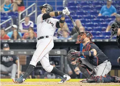  ?? MARK BROWN/GETTY IMAGES ?? Miami’s Starlin Castro launches his three-run homer to left in the seventh inning of Tuesday’s game against the Atlanta Braves. The Marlins earned a split of the two-game series.
