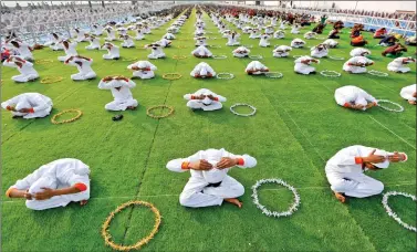  ?? REUTERS ?? School children attend a yoga session on Saturday during a week-long camp in Ahmedabad.