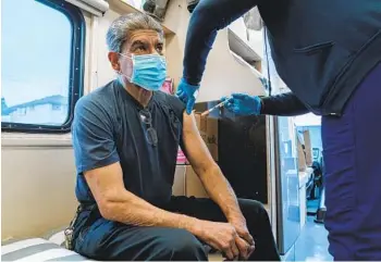  ?? ARIANA DREHSLER ?? Hector Sanchez, an auto mechanic for the San Diego Unified School District’s vehicle fleet, receives the Moderna booster shot for COVID-19 at Crawford High School in El Cerrito on Wednesday.