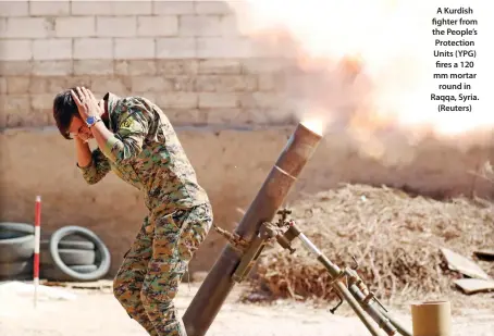  ??  ?? A Kurdish fighter from the People’s Protection Units (YPG) fires a 120 mm mortar round in Raqqa, Syria. (Reuters)