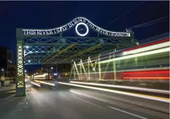  ?? CARLOS OSORIO/TORONTO STAR ?? The Riverside Bridge, built in 1911, was lit up for the first time Friday with Pan Am Games colours.