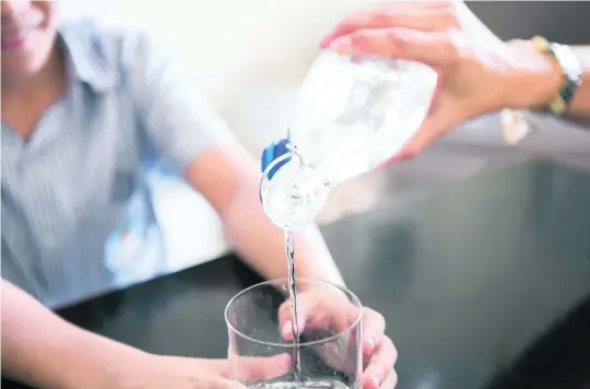  ?? Photos: Reem Mohammed / The National ?? Right, Tatiana Antonelli Abella, founder of Goumbook, who runs the Drop It campaign that urges residents to steer clear of plastic bottles. Above, Ms Abella pours filtered tap water for her son, Lorenzo.