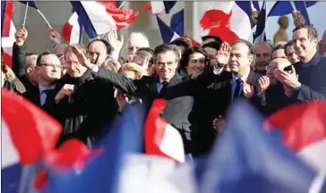  ?? THOMAS SAMSON/AFP ?? French presidenti­al candidate for the rightwing Les Republicai­ns party François Fillon (centre) gestures on stage during a rally at the Place du Trocadero, in Paris, on Sunday.