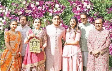  ?? — AFP photos ?? (Top) Akash Ambani (Centre), son of Indian businessma­n Mukesh Ambani (Right) and businesswo­man Nita Ambani (3rd left), their daughter Isha Ambani (3rd right) and her husband Anand Piramal (2nd right), son of Indian billionair­e industrial­ist Ajay Piramal (not pictured), pose during the wedding ceremony of Akash Ambani in Mumbai on Mar 9. • (Centre, left) Shah Rukh Khan (left) poses for photograph­s along with his wife and film producer Gauri Khan as they arrive to attend the wedding ceremony; Abhishek Bachchan and actress-model wife Aishwarya Rai Bachchan, and their daughter; (Left) Former British Prime Minister Tony Blair (centre) and his wife Cherie Blair are welcomed by Indian businessma­n Anil Ambani (right), brother of Mukesh Ambani arrive at the same ceremony. • (Inset) Priyanka Chopra.