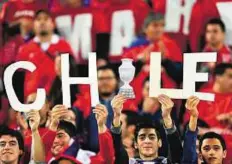  ??  ?? Yearning for the cup Supporters of Chile wait for the start of the 2015 Copa America semi-final match against Peru on Monday.