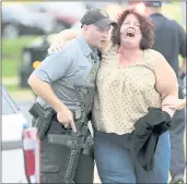  ?? STEVE APPS — WISCONSIN STATE JOURNAL VIA AP ?? A woman is escorted from the scene of a shooting at a software company in Middleton, Wis., Wednesday.