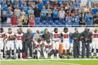  ?? THE ASSOCIATED PRESS ?? Atlanta Falcons defensive tackles Grady Jarrett (97) and Dontari Poe (92) take a knee during the national anthem before an NFL football game Sunday in Detroit. Other teammates join arms with them to show solidarity.