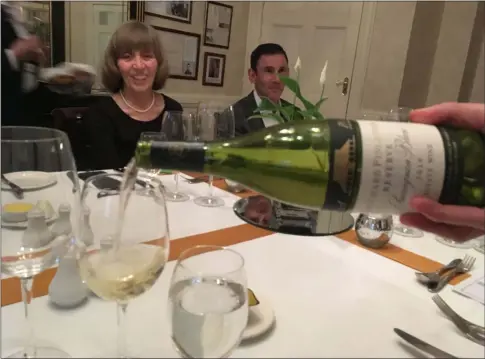  ?? JANET PODOLAK — THE NEWS-HERALD ?? A South African wine is poured for a formal Taste of Guernsey dinner at the Old Government House.