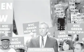  ?? — AFP photo ?? Protesters gather as De Blasio holds a Green New Deal rally At Trump Tower in New York City.