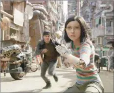  ?? TWENTIETH CENTURY FOX ?? The newly awakened Alita (Rosa Salazar) instinctua­lly takes a fighting stance when threatened as Hugo (Keean Johnson) runs to her aid in a scene from “Alita: Battle Angel.”