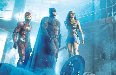  ?? HANDOUT ?? This image shows Ezra Miller, from left, Ben Affleck and Gal Gadot in a scene from Justice League. The DC superhero film will be released Nov. 17.