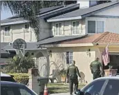  ?? Robert Gauthier Los Angeles Times ?? SAN BERNARDINO COUNTY deputies investigat­e the triple homicide in Montclair on Tuesday.