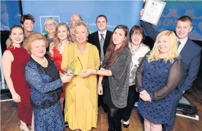  ??  ?? Pictured, front, from left to right, are Lady Gretton, Julie Cooke of ONE Kegworth and Danielle Garrity of award sponsor Smallman, with the ONE Kegworth team.