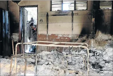  ?? PHOTO: SANDILE NDLOVU ?? Minister for Basic Education Angie Motshekga inspects damage at Vhafamadi Primary School which was burnt by protesters in Mashau village, Limpopo.