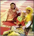  ??  ?? The mother (right) of Abdillah Masid, 15, cries beside her son’s dead body inside the Camp Ranao Mosque in Barangay Saber in Marawi, on the southern Philippine island of Mindanao on June 9. Abdillah died after a stray bullet hit him in the neck during...