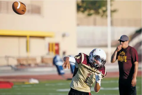  ??  ?? Quarterbac­k Shaun Riley throws a pass during practice Monday at Santa Fe Indian School.